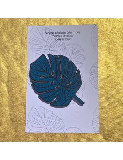 Broche monstera fond bleu dessin blanc pailleté or